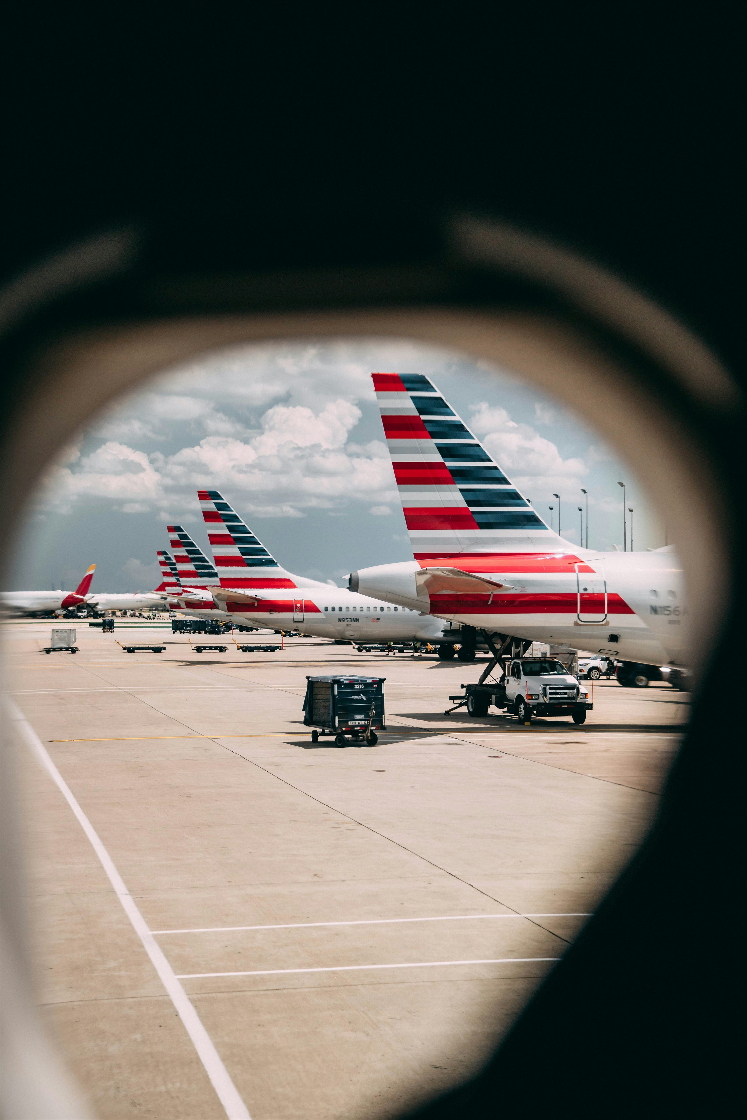 American Airlines aircraft tail fins seen through a porthole window — still from American × Kyndryl interview series