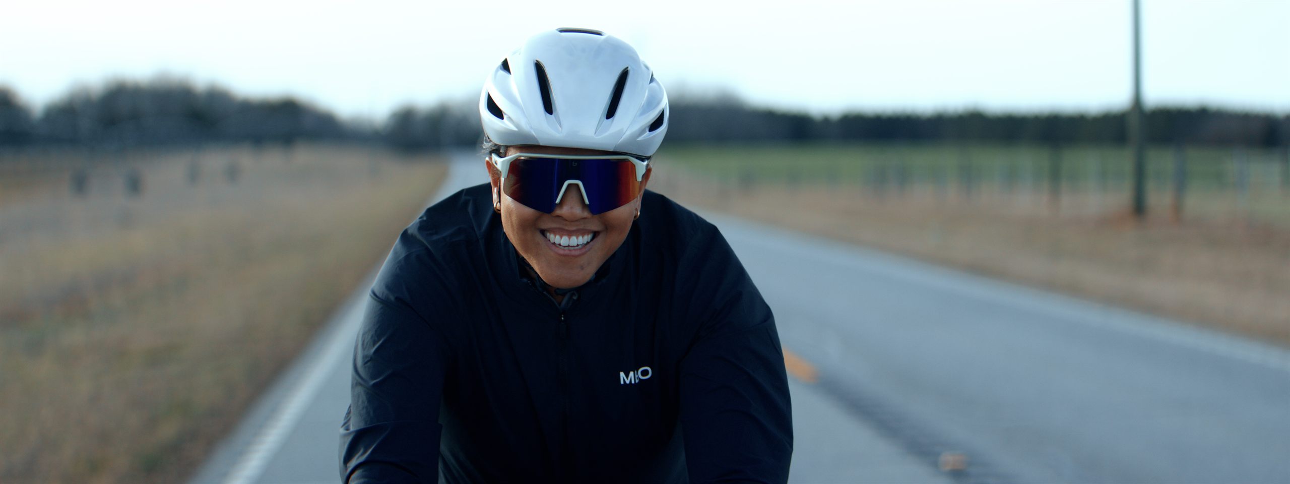 Cyclist with reflective sunglasses, Carolina back road, still from Cycling spec ad