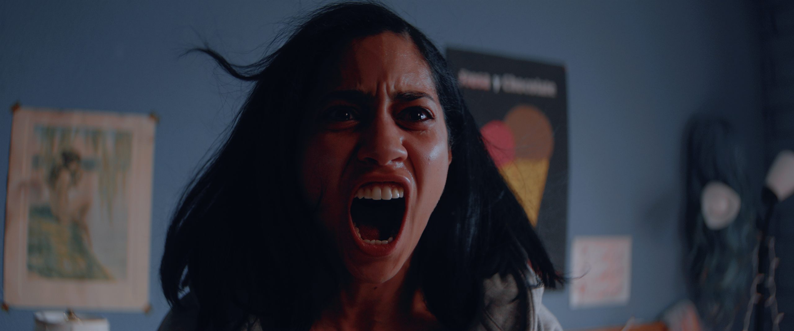 A still from HAND, a Filmit-produced narrative short — Sharlene Cruz in a horror-genre lighting setup